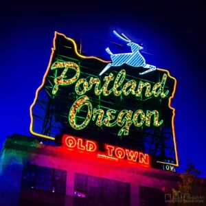 White Stag Portland, Oregon neon sign glowing gold at dusk — Noir10 handmade LED backlit print