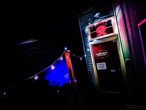 Advice Booth neon entrance glowing red and at night — Noir10 handmade LED backlit print