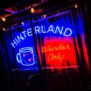Hinterland coffee shop neon sign glowing red and blue at night — Noir10 handmade LED