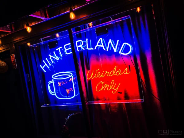 Hinterland coffee shop neon sign glowing red and blue at night — Noir10 handmade LED
