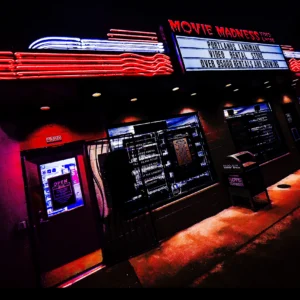 Movie Madness neon sign glowing red at night — Noir10 handmade LED backlit print