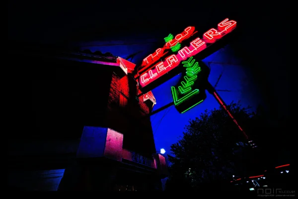 Tip Top neon sign glowing red and green at dusk — Noir10 handmade LED backlit print