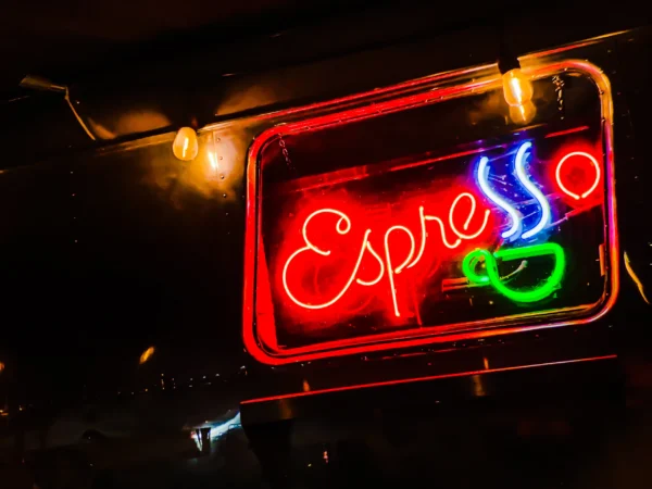 Coffee cart neon sign glowing red and green at night — Noir10 handmade LED backlit print