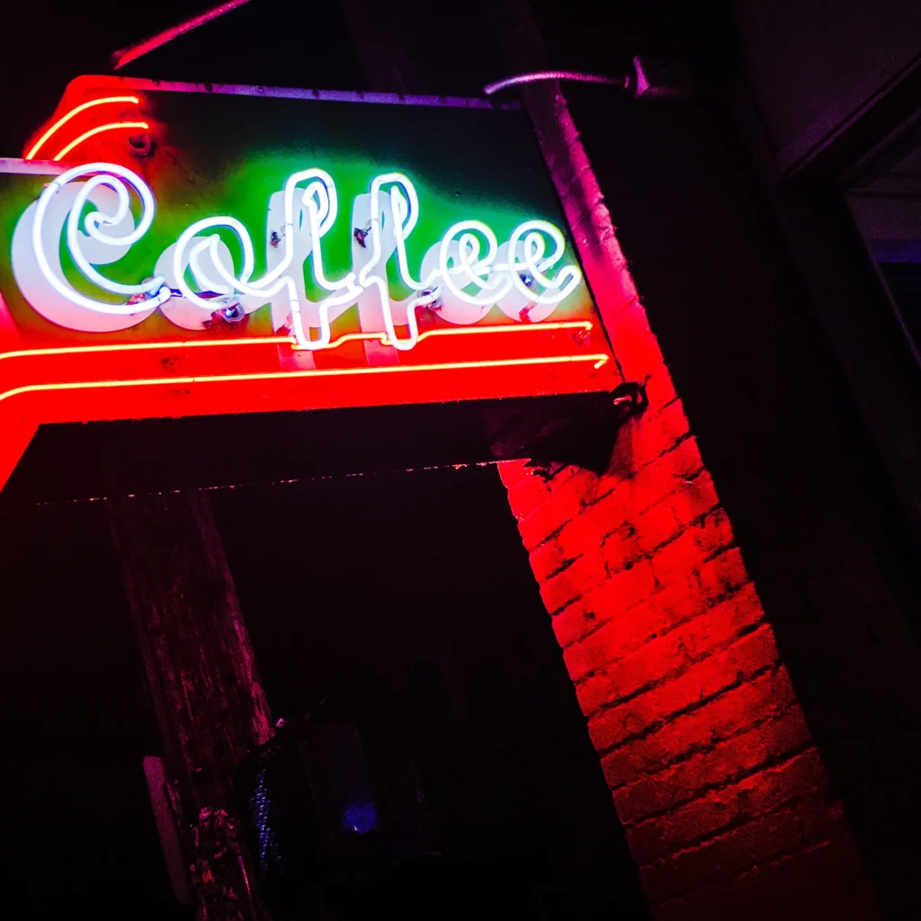 Stumptown Coffee neon sign glowing red at night — Noir10 handmade LED backlit print