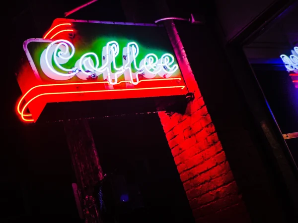 Stumptown Coffee neon sign glowing red at night — Noir10 handmade LED backlit print
