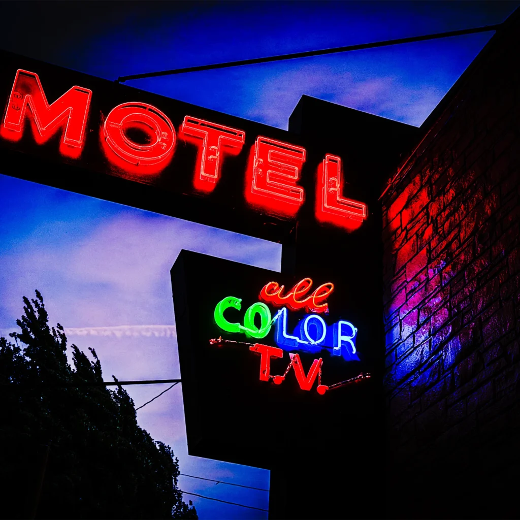 PDX motel neon sign glowing red, green blue at dusk — Noir10 handmade LED backlit print