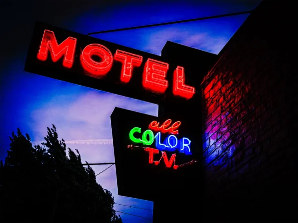 PDX motel neon sign glowing red, green blue at dusk — Noir10 handmade LED backlit print