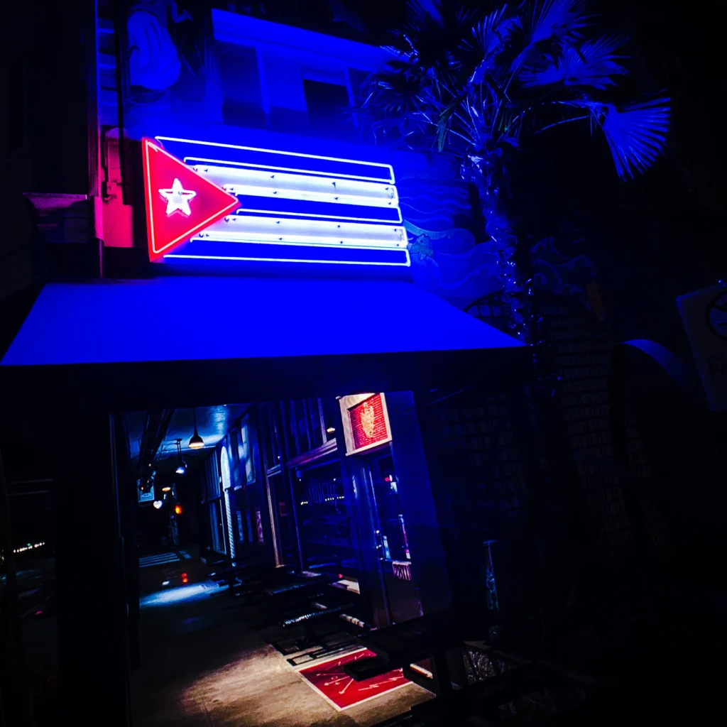 Pambiche neon sign glowing blue at night — Noir10 handmade LED backlit print
