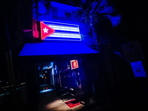 Pambiche neon sign glowing blue at night — Noir10 handmade LED backlit print