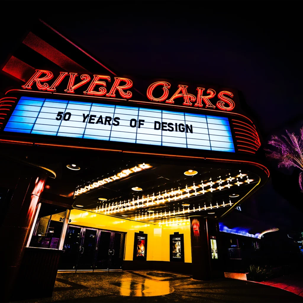 River Oaks theater neon marquee glowing red and yellow at night — Noir10 handmade LED