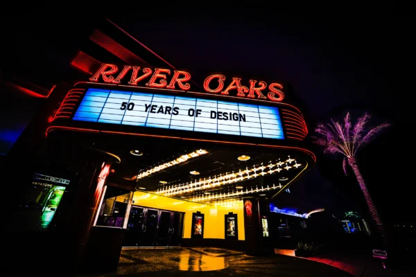 River Oaks theater neon marquee glowing red and yellow at night — Noir10 handmade LED