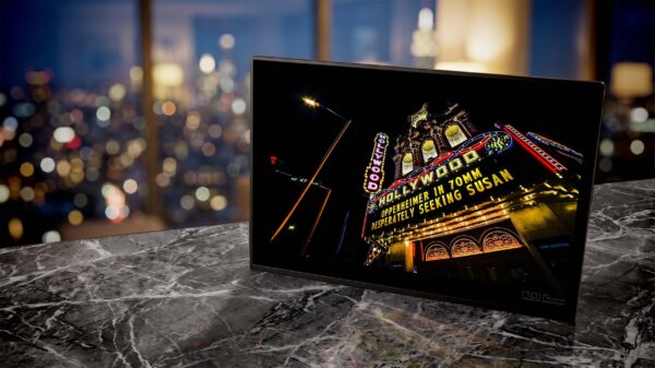 Hollywood Theater neon sign glowing yellow at night — Noir10 handmade LED backlit print