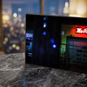 Mr. Plywood neon sign glowing red in living room — Noir10 handmade LED backlit print