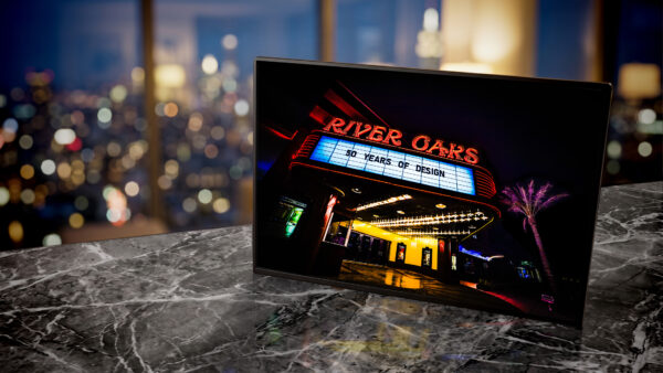 River Oaks theater neon marquee glowing red and yellow at night — Noir10 handmade LED backlit print