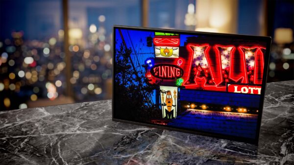 Alibi Tiki Lounge neon sign glowing red at dusk — Noir10 handmade LED backlit print